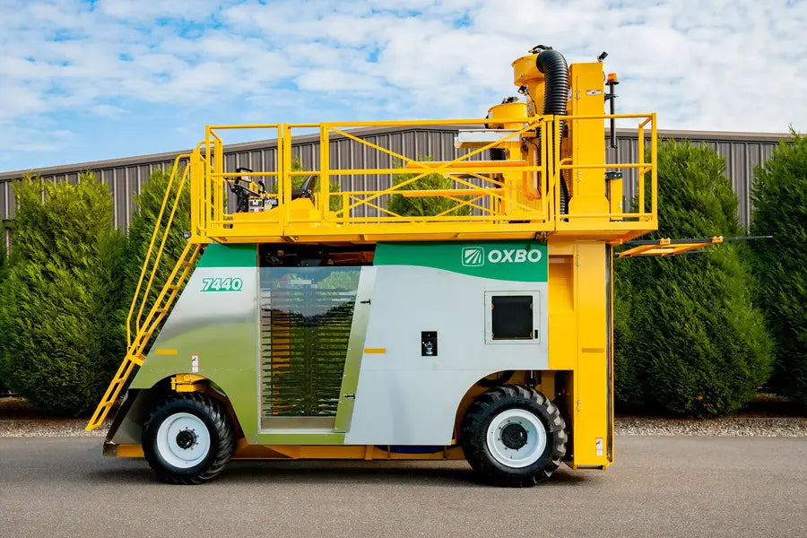 Oxbo 7440 4-wheeled top-load blueberry harvester